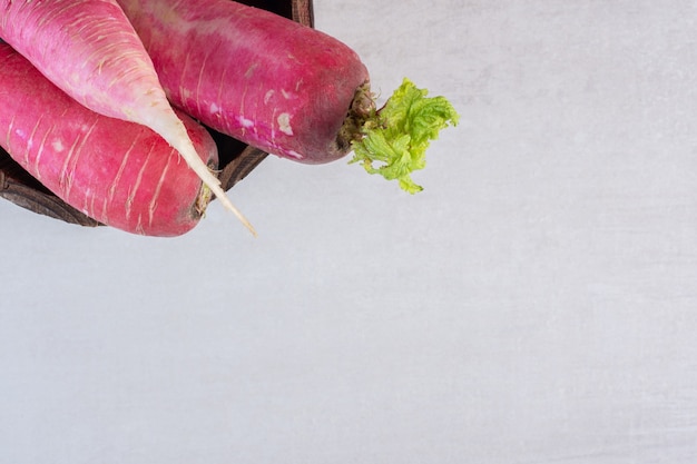 Free photo fresh red radishes in wooden bucket. high quality photo