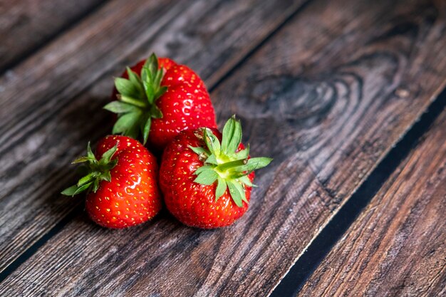 Fresh red Scottish strawberries on top of wooden table