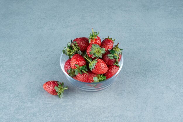 Fresh red strawberries in glass bowl.