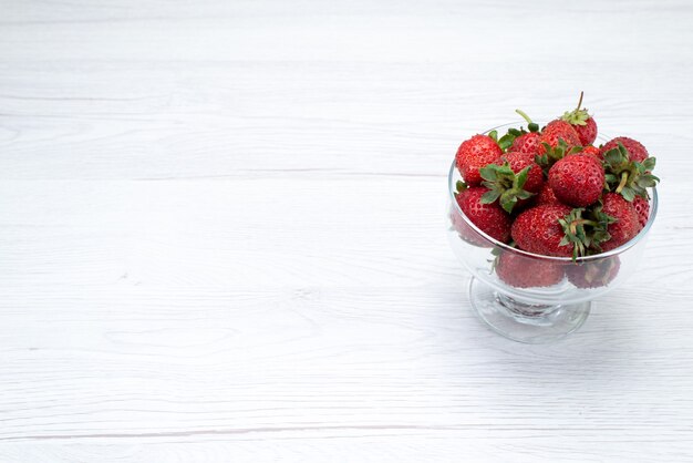 fresh red strawberries inside transparent plate on light white