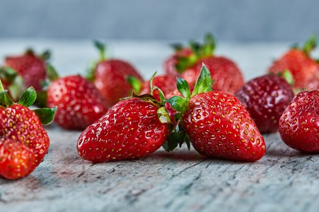 Fresh red strawberries on marble surface