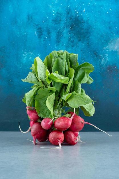 Fresh red turnips on marble.