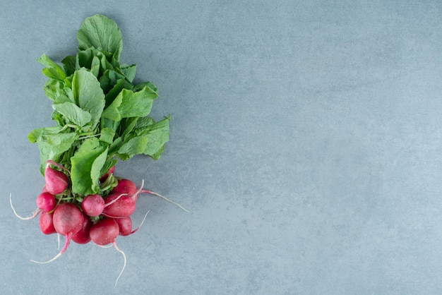 Fresh red turnips on marble.