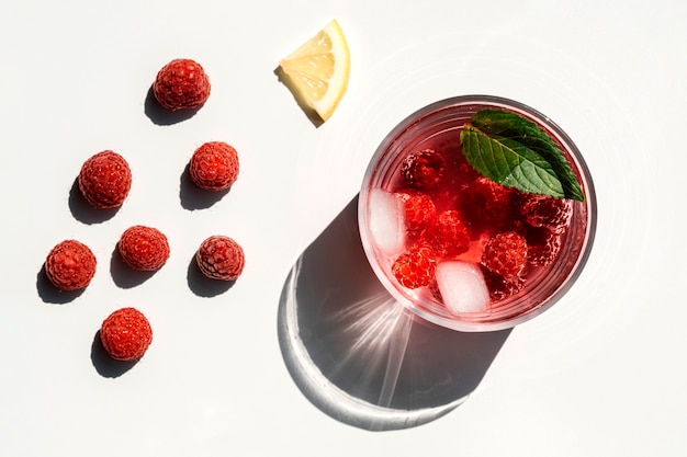 Fresh ripe raspberries and raspberry juice in a glass 