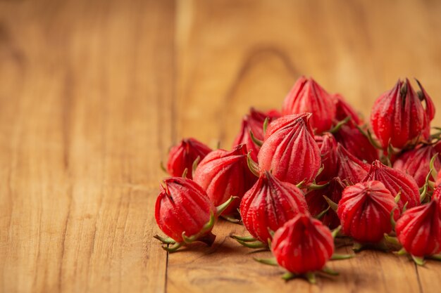 Fresh sabdariffa hibiscus or Roselle placed on an old wooden floor.