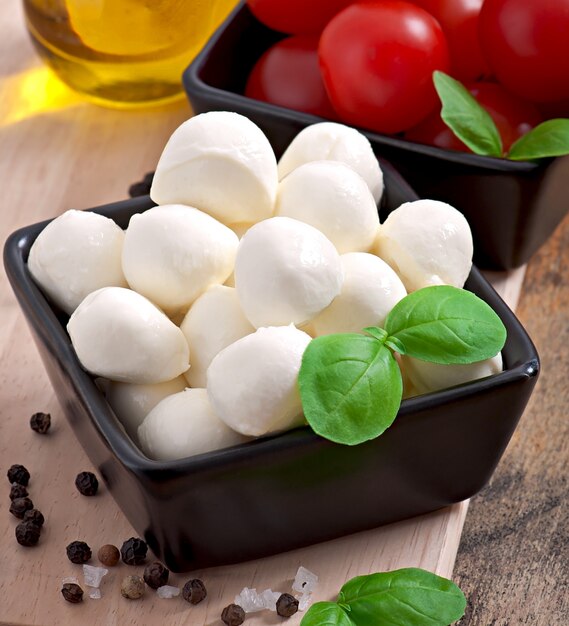 Fresh salad with cherry tomatoes, basil, mozzarella and black olives.