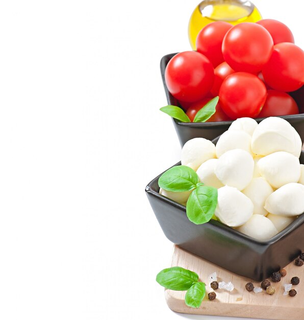 Fresh salad with cherry tomatoes, basil, mozzarella and black olives.