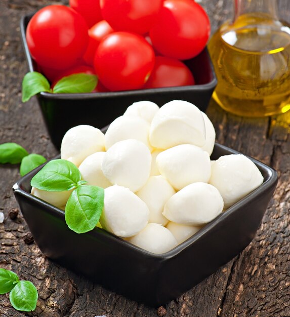 Fresh salad with cherry tomatoes, basil, mozzarella and black olives.