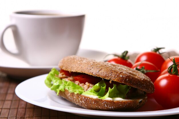 Fresh sandwich with fresh vegetables and coffee