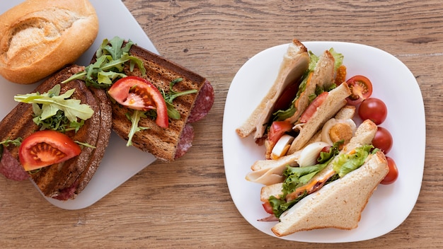 Fresh sandwiches arrangement on wooden background