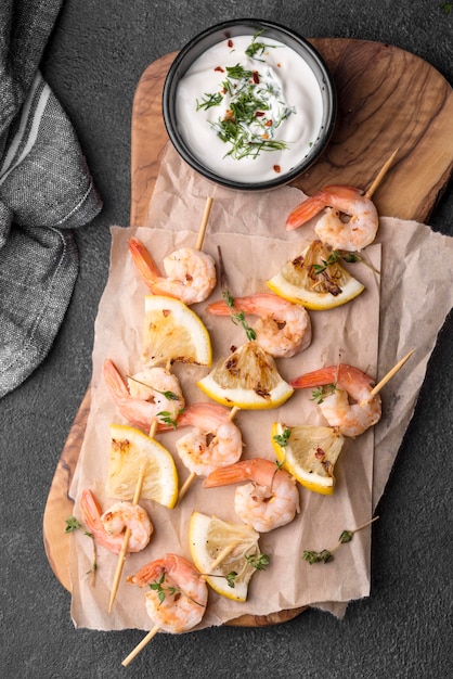 Free photo fresh seafood shrimp skewers on wooden board