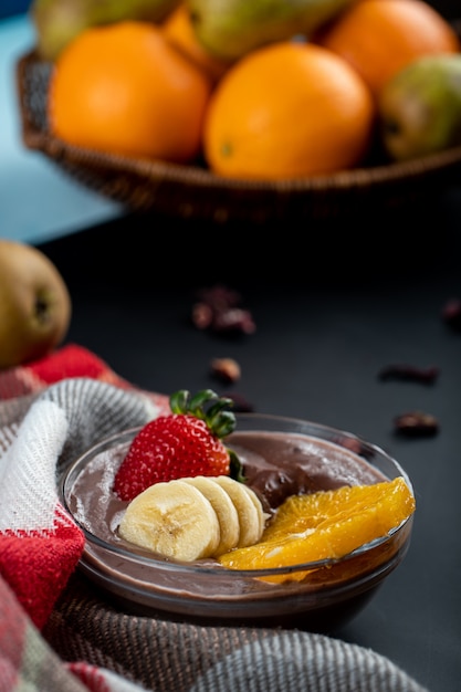 Fresh sliced banana, strawberry,orange in a saucer