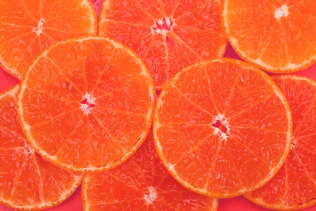 Fresh sliced juicy orange fruit set over orange  - tropical orange fruit texture for  use