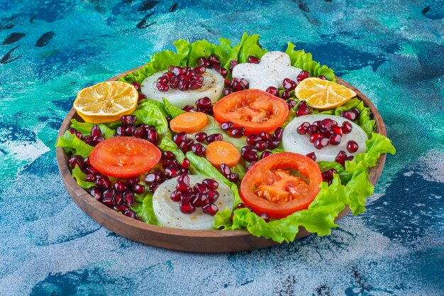 Fresh, sliced various vegetables on a wooden plate