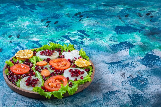 Fresh, sliced various vegetables on a wooden plate