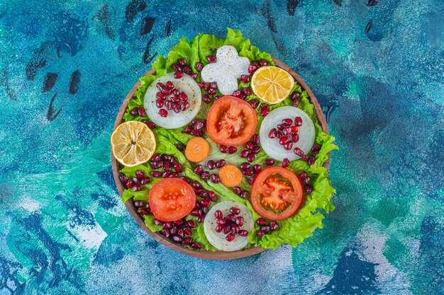 Fresh, sliced various vegetables on a wooden plate