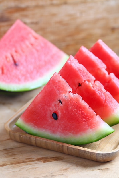 Fresh sliced watermelon on wooden background