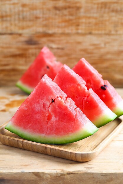 Fresh sliced watermelon on wooden background