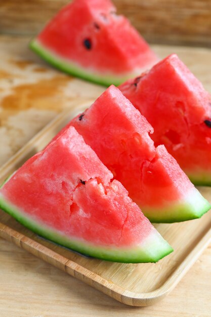 Fresh sliced watermelon on wooden background