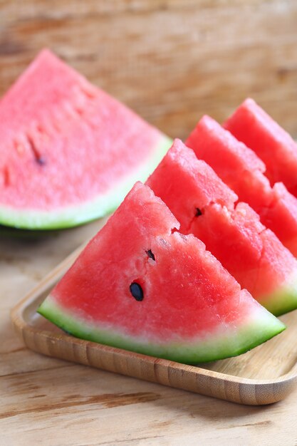 Fresh sliced watermelon on wooden background