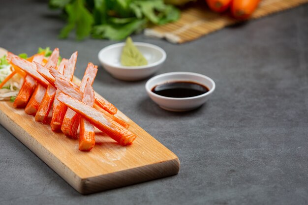 Fresh slides of crab sticks with wasabi and sauce