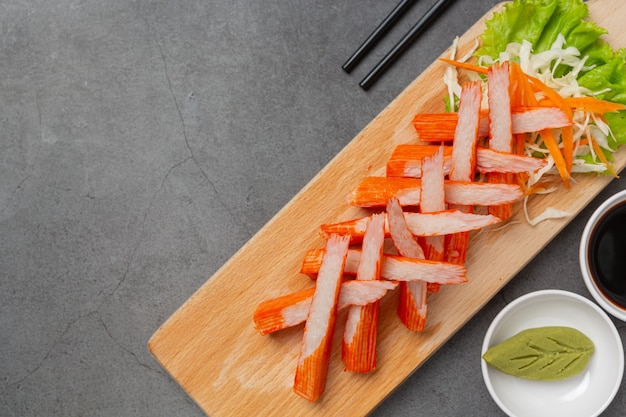 Fresh slides of crab sticks with wasabi and sauce