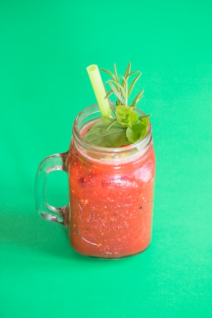 Free photo fresh smoothie in mason jar on green background