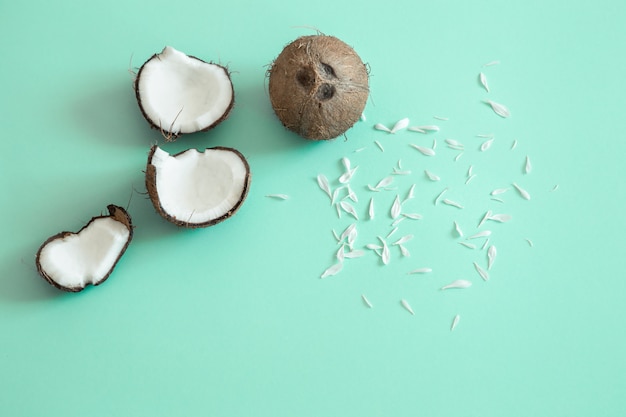 Fresh split coconut on a blue background.