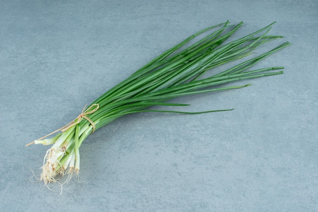 Fresh spring onions on marble.