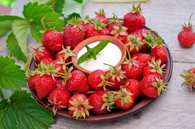 Fresh strawberries in a basket on a table in the garden