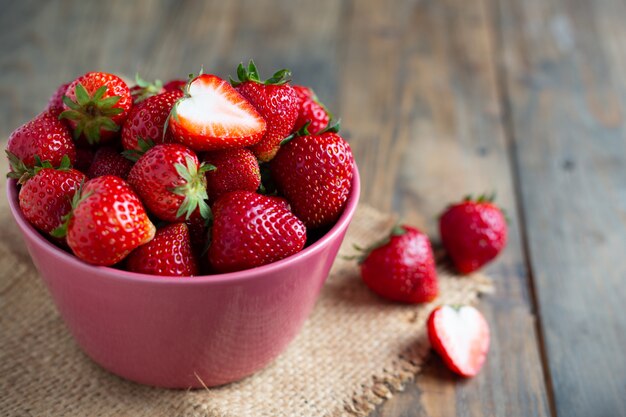 Fresh strawberries on wooden table.