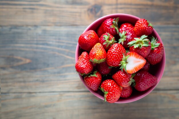 Fresh strawberries on wooden table.