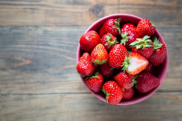 Fresh strawberries on wooden table.