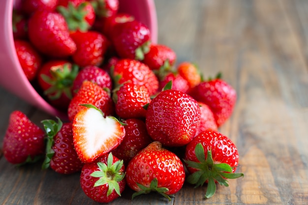 Fresh strawberries on wooden table.