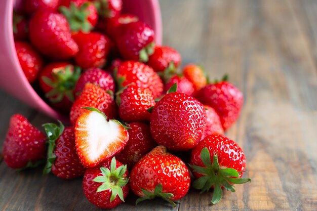 Fresh strawberries on wooden table.