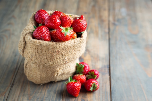 Fresh strawberries on wooden table.