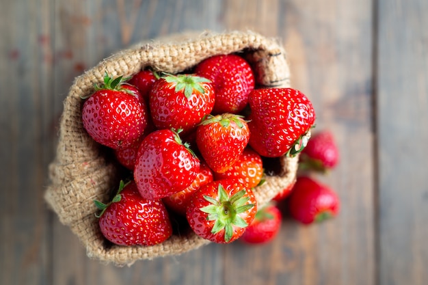 Fresh strawberries on wooden table.