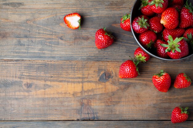 Fresh strawberries on wooden table.