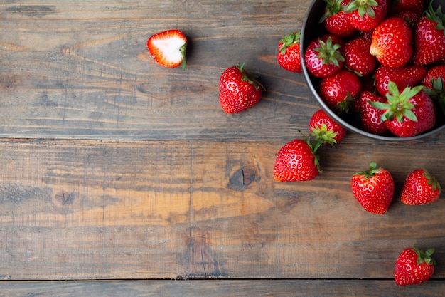 Fresh strawberries on wooden table.