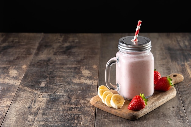 Fresh strawberry and banana smoothie in jar
