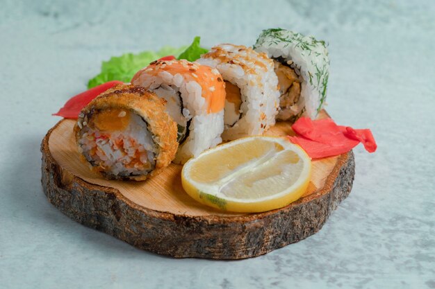 Fresh sushi rolls on wooden surface. 