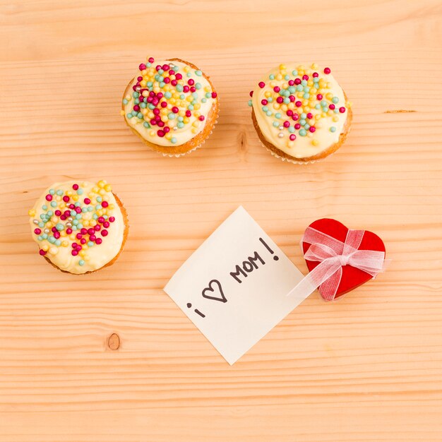 Fresh tasty cupcakes with decorative heart