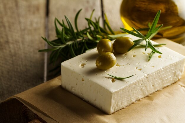Fresh tasty greek green olives with cheese feta or goat cheese. Closeup. Mediterranean food.