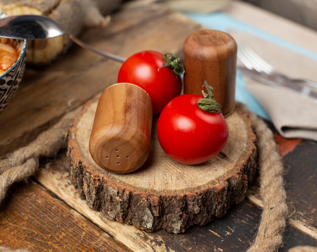 Fresh tomatoes on a piece of wood.