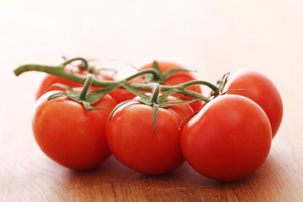 Fresh tomatoes on wooden surface