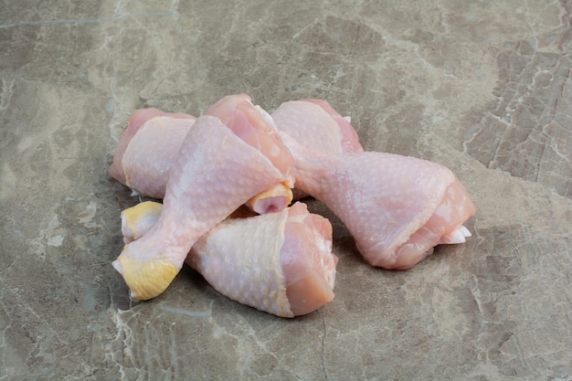 Fresh uncooked chicken legs on marble background. High quality photo