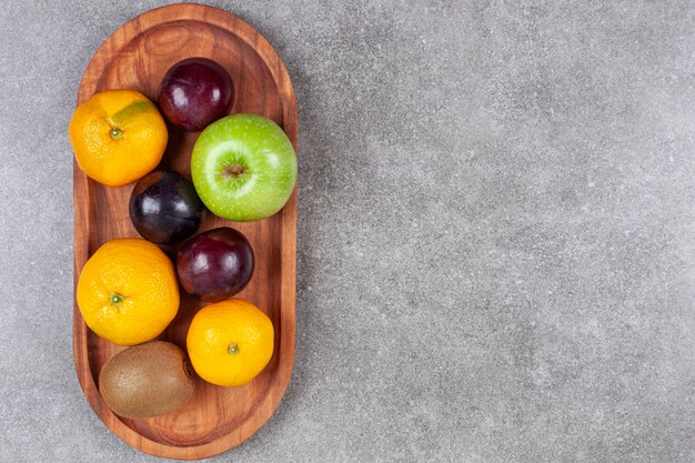 Fresh various fruits on a wooden kitchen board