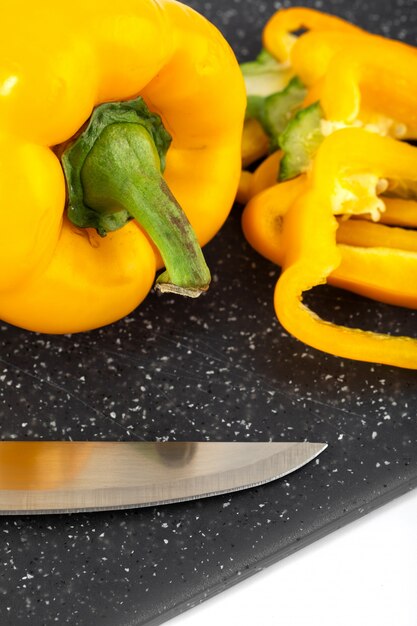 Fresh vegetable ripe mellow yellow bell pepper on dark desk and white background