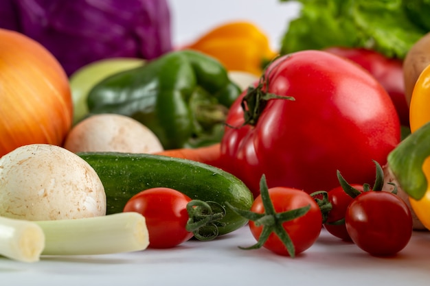 Fresh vegetables colored ripe on white desk