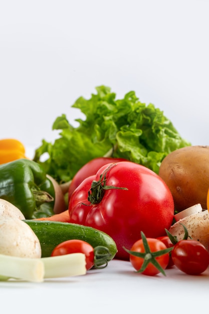 Free photo fresh vegetables colored salad vegetabes on white background